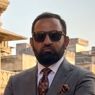 Amin, private chauffeur in Mumbai, standing beside his car